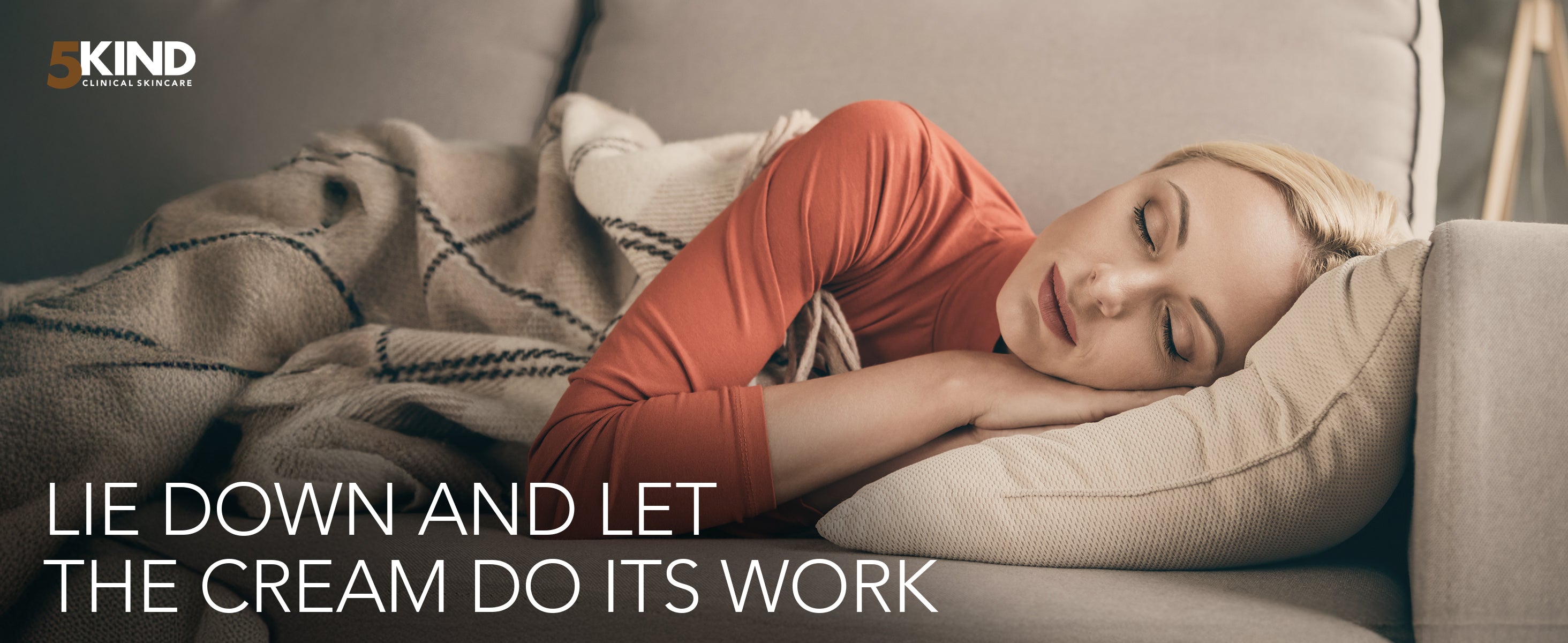 Woman lying on a couch with a blanket, promoting a product with text 'LIE DOWN AND LET THE CREAM DO ITS WORK'.